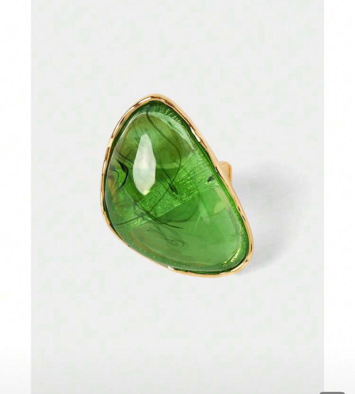 Oval yellow imitation amber ring with rose gold bezel on white background